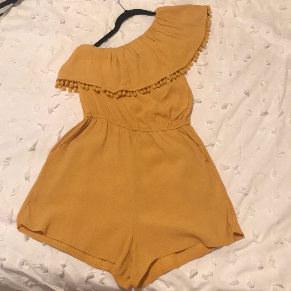 One-shoulder mustard yellow romper with Pom-poms